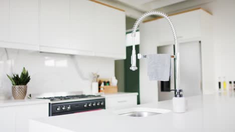 Close-up-of-sink-and-equipment-in-kitchen,-slow-motion