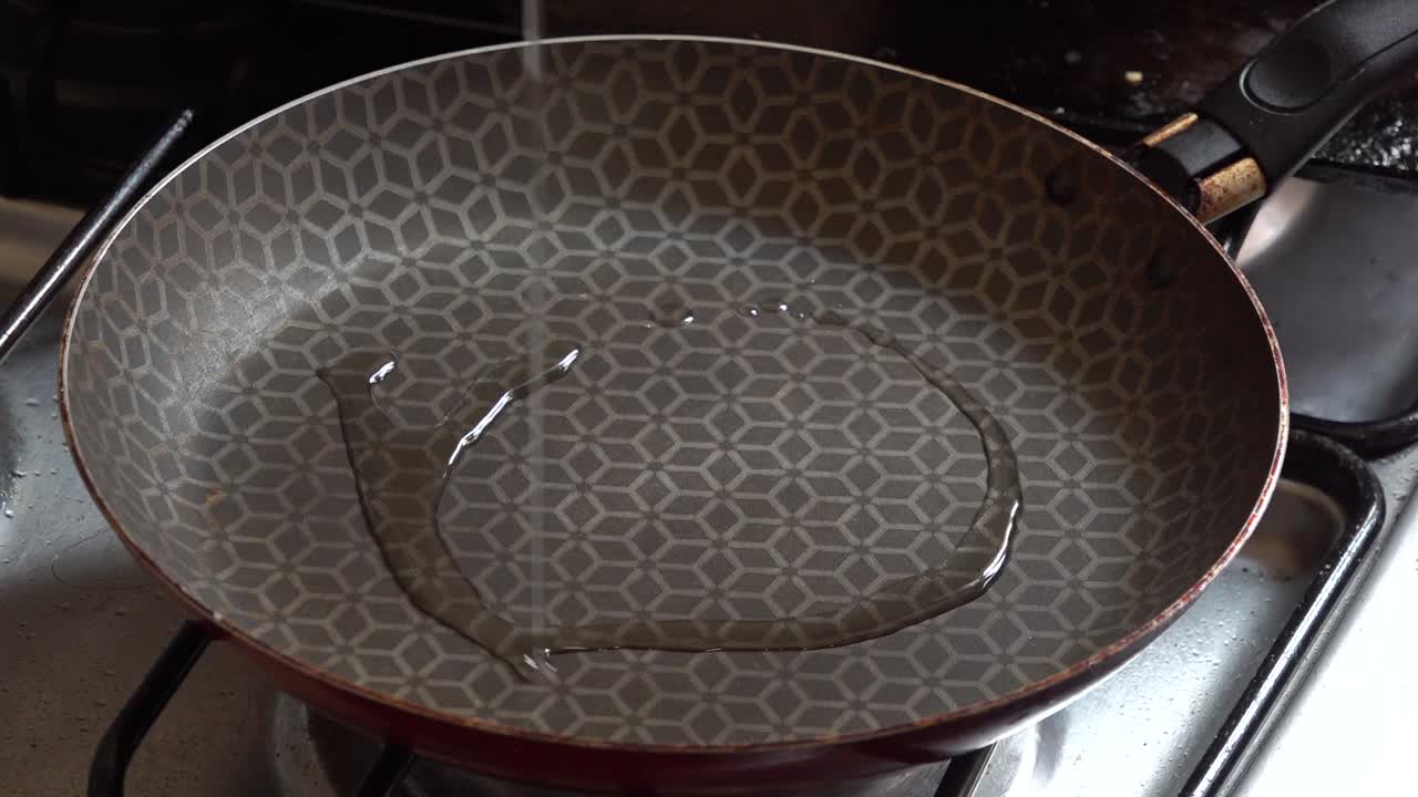 Oil being poured on a pan