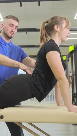 physical therapist assisting patient with back exercises