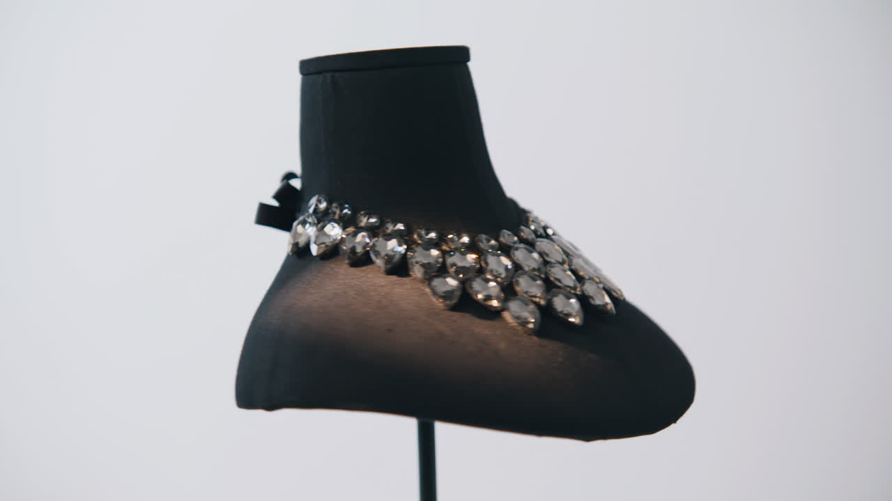 Luxury necklace fastened mannequin under clear light. Transparent stones shining