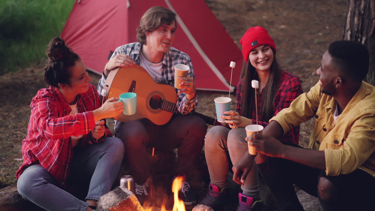 Friends Camping and Making Memories by the Campfire