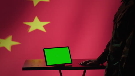 Chinese-intelligence-agency-operator-using-green-screen-tablet-to-do-propaganda