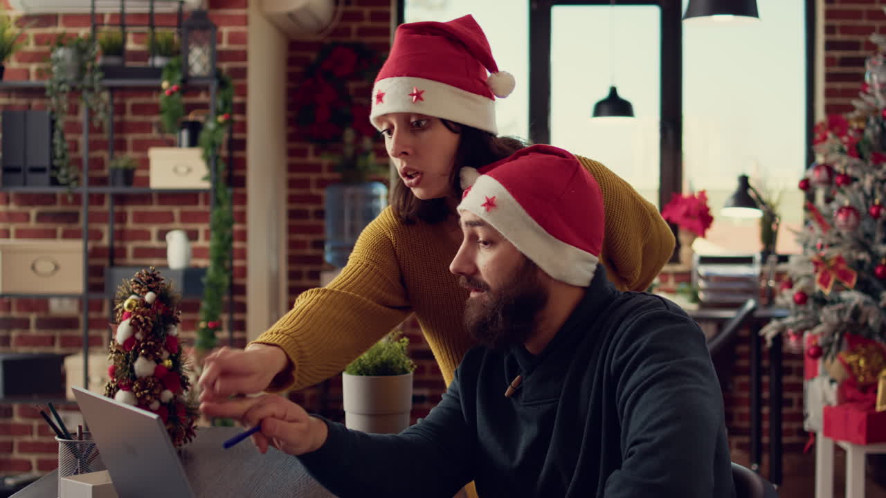 Team of colleagues analyzing report on laptop during christmas eve