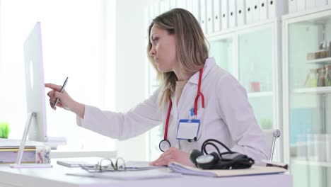 Female Doctor Working at Her Desk in a Clinic Office