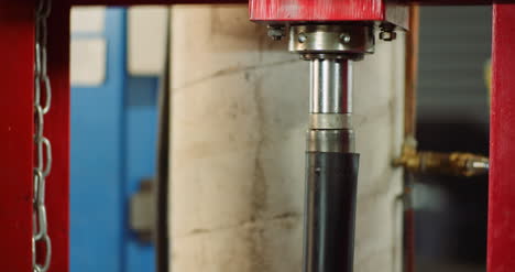 lockdown shot of shock absorber pressing machine at car workshop