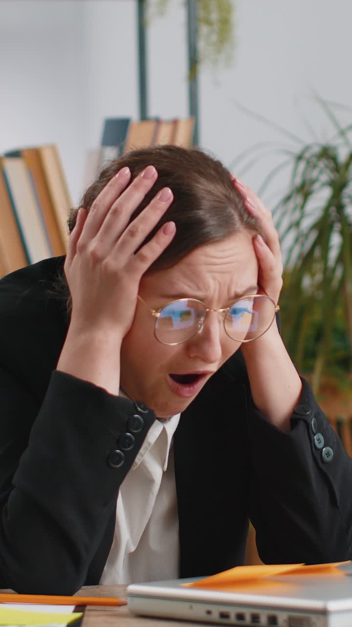 Tired sad exhausted businesswoman working on laptop at office with many sticker tasks panic attack