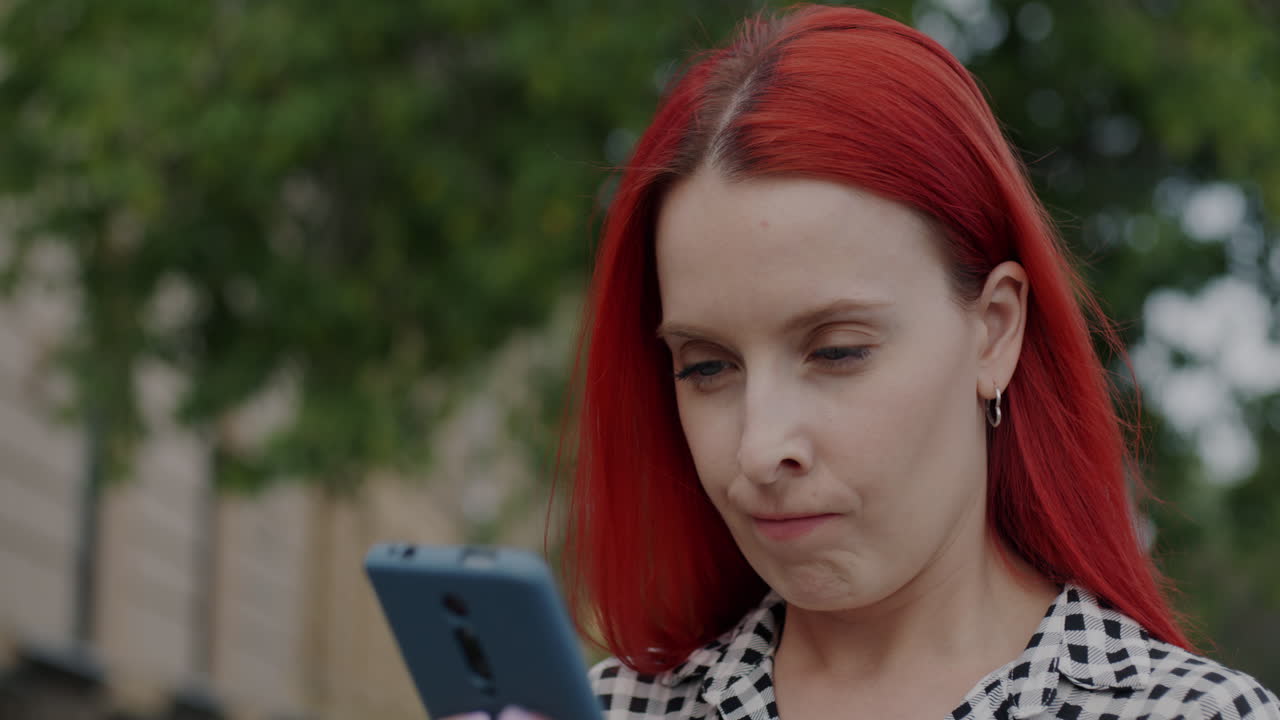 Woman looking at smartphone with surprised expression