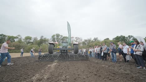 demonstration of agricultural machinery at an exhibition. tractors operate in the field, showcasing their capabilities and performance in action