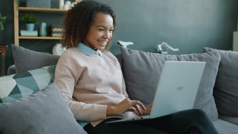 young woman working on laptop at home