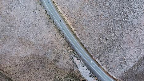 Blick-Von-Oben-Auf-Ein-Auto,-Das-Auf-Einer-Autobahn-In-Der-Argentinischen-Provinz-Salta-Fährt,-Drohnen-Umlaufbahn-über-Dem-Kopf