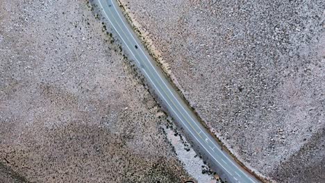 overhead view of a car driving along a highway in the salta province, argentina, drone overhead orbit