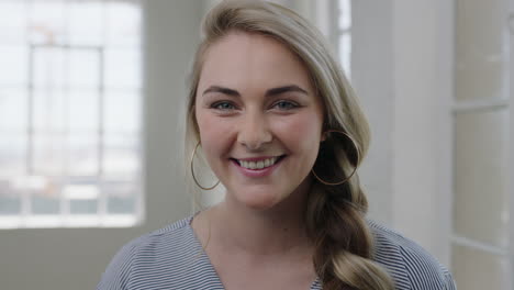 portrait of beautiful young blonde woman smiling happy looking at camera