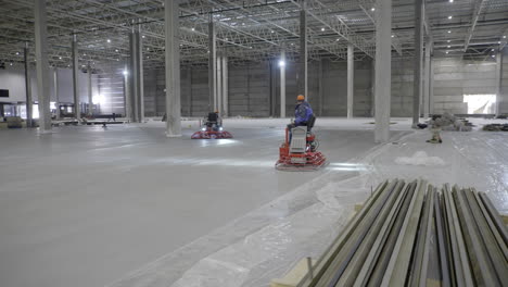 workers pouring concrete floor in a warehouse