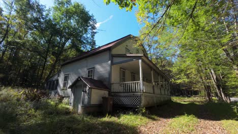 empty house in rural landscape of mont sutton during summer in quebec, canada. dolly-in shot