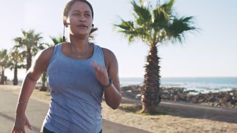 Fitness,-music-and-running-with-woman-at-the-beach