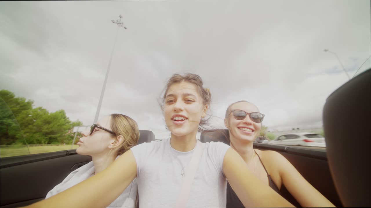 Three Young Women Enjoying a Convertible Road Trip