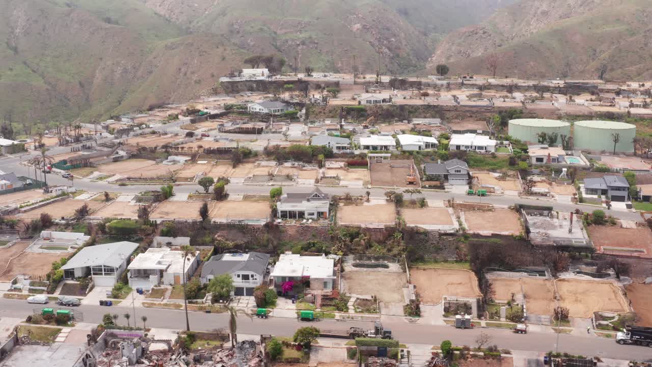 Aerial close-up panning shot of homes burned by the Palisades Fire in the upscale Sunset Mesa neighborhood of Malibu, California. 4K