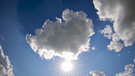 beautiful blue sky with fluffy clouds and sunbeams