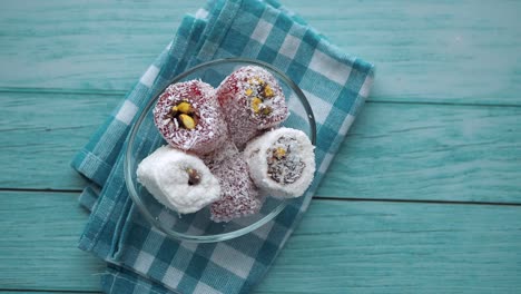 assorted turkish delight in glass bowl on blue wooden table