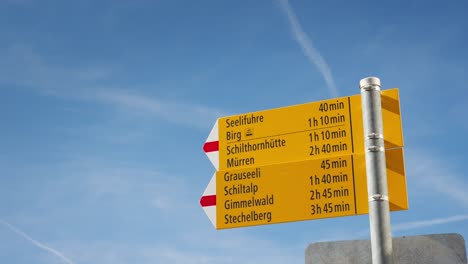 yellow sign pointing to the nearest town in the lauterbrunnen valley area in switzerland