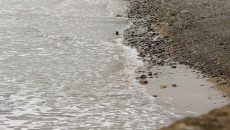 sea rolling in over pebbly beach