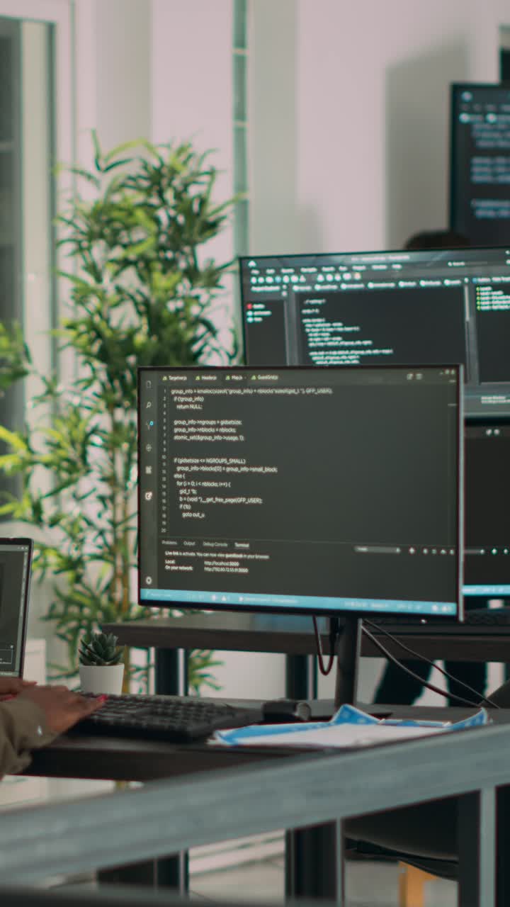 Vertical video: African american team of cloud programers talking about programming compiling code
