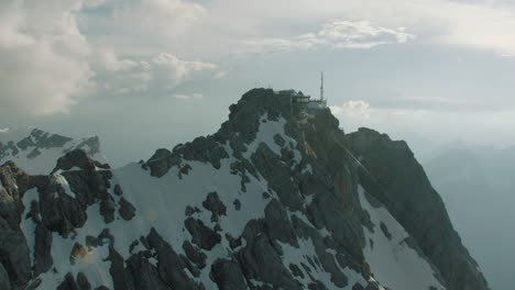 top weather station on the zugspitze mountain at sunset