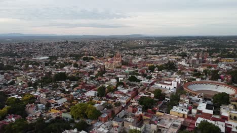 Aerial-view-over-the-historic-cityscape-of-San-Miguel-De-Allende-during-a-trip-through-Mexico-with-view-of-the-neo-Gothic-church-Parroquia-de-San-Miguel-Arcángel-and-colorful-buildings