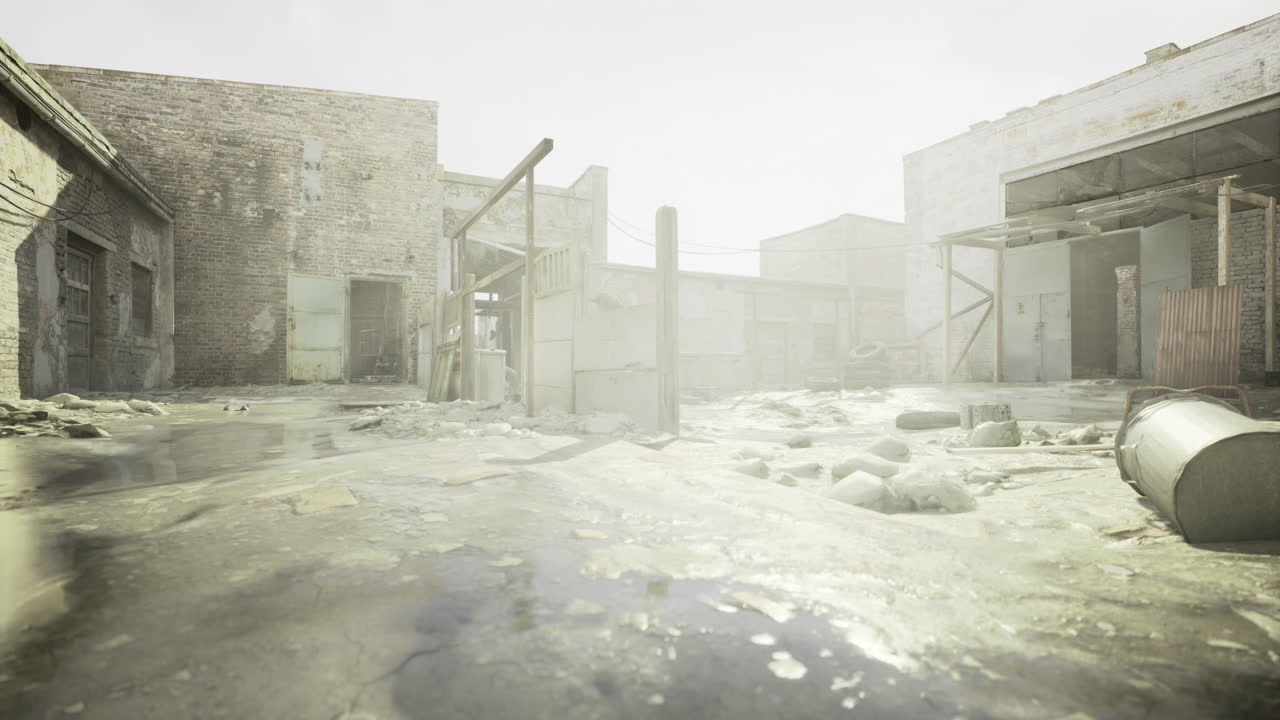 Abandoned industrial area with sunlight reflecting on wet ground