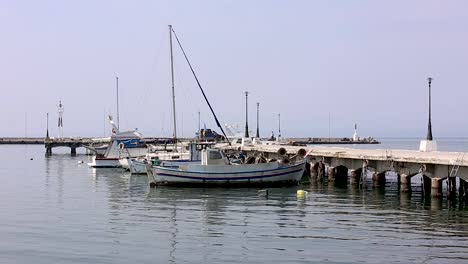 Small-fishing-boats-at-the-harbor-pier,-Greece-Thessaloniki