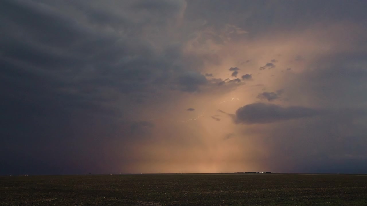 Dynamic night clouds glowing with repeated lightning activity