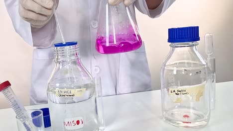 A scientist mixes vibrant pink liquid in a lab, showcasing chemical interaction.