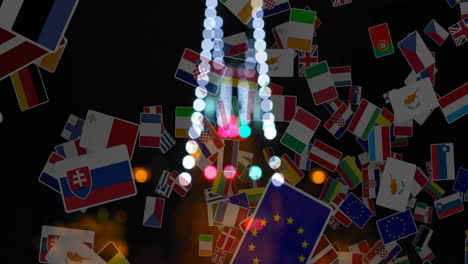 european flags waving over blurred lights background