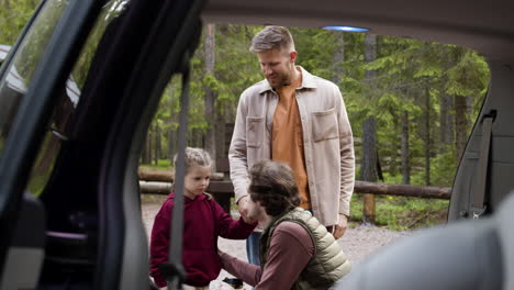 family getting ready to travel on big car