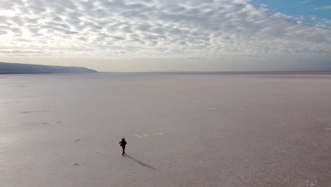 Beautiful-girl-walking-on-the-pink-salt-lake,-the-largest-dry-lake-in-Turkey-and-one-of-the-largest-salt-lakes-the-world