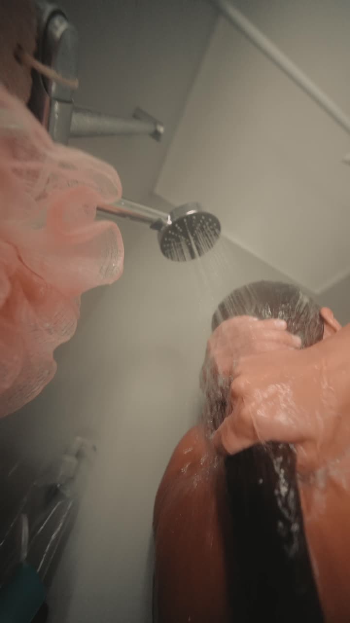 Woman Washing Her Long Hair Under a Shower
