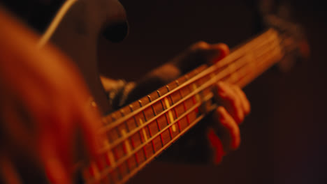 close up of fingers playing bass guitar-1