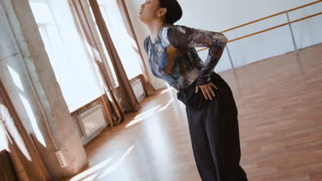 woman dancing expressively in a bright studio