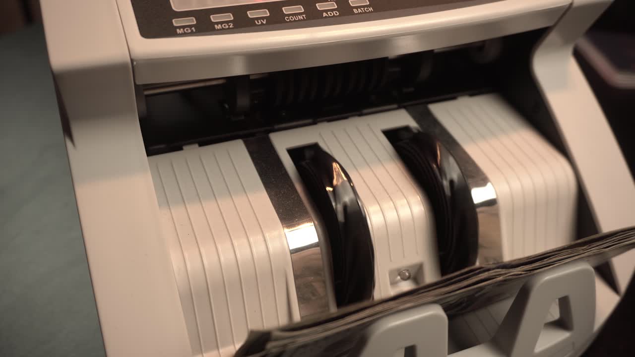 US Dollars in Counting Money Machine, Close Up Slow Motion