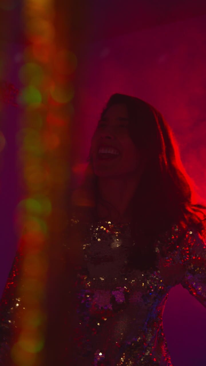 Vertical Video Of Woman In Nightclub Bar Or Disco Dancing With Sparkling Lights And Dry Ice In Background