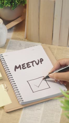 vertical video of ticking off meetup from checklist