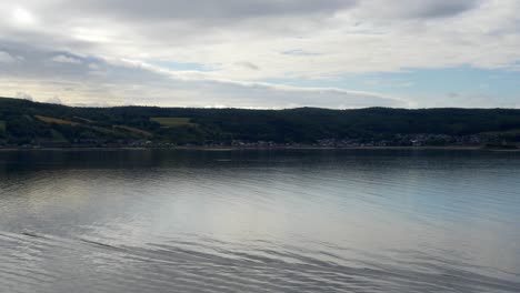 view of mountains from the stern of a ship cruising along saguenay fjord outside of la baie, qc, canada