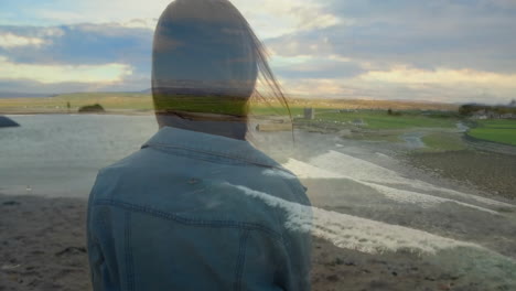 wearing denim jacket, person overlooking ocean waves and fields in scenic view