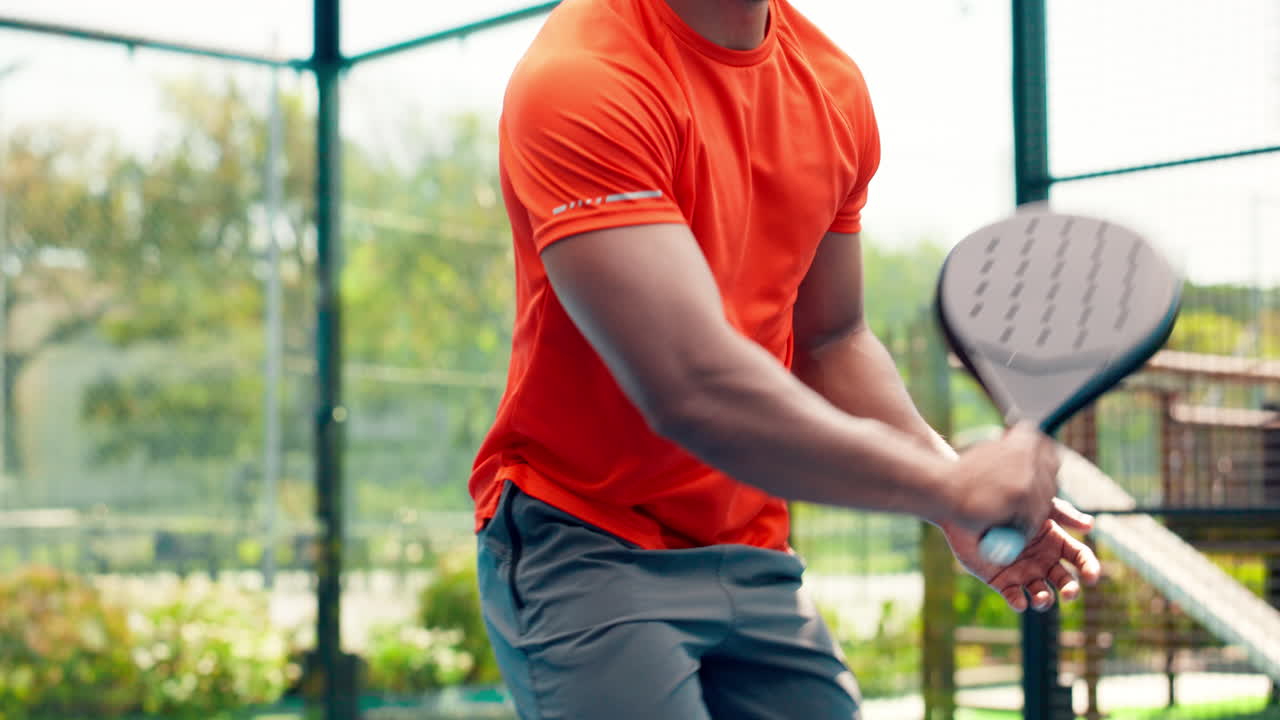Young Man Playing Padel on an Outdoor Court