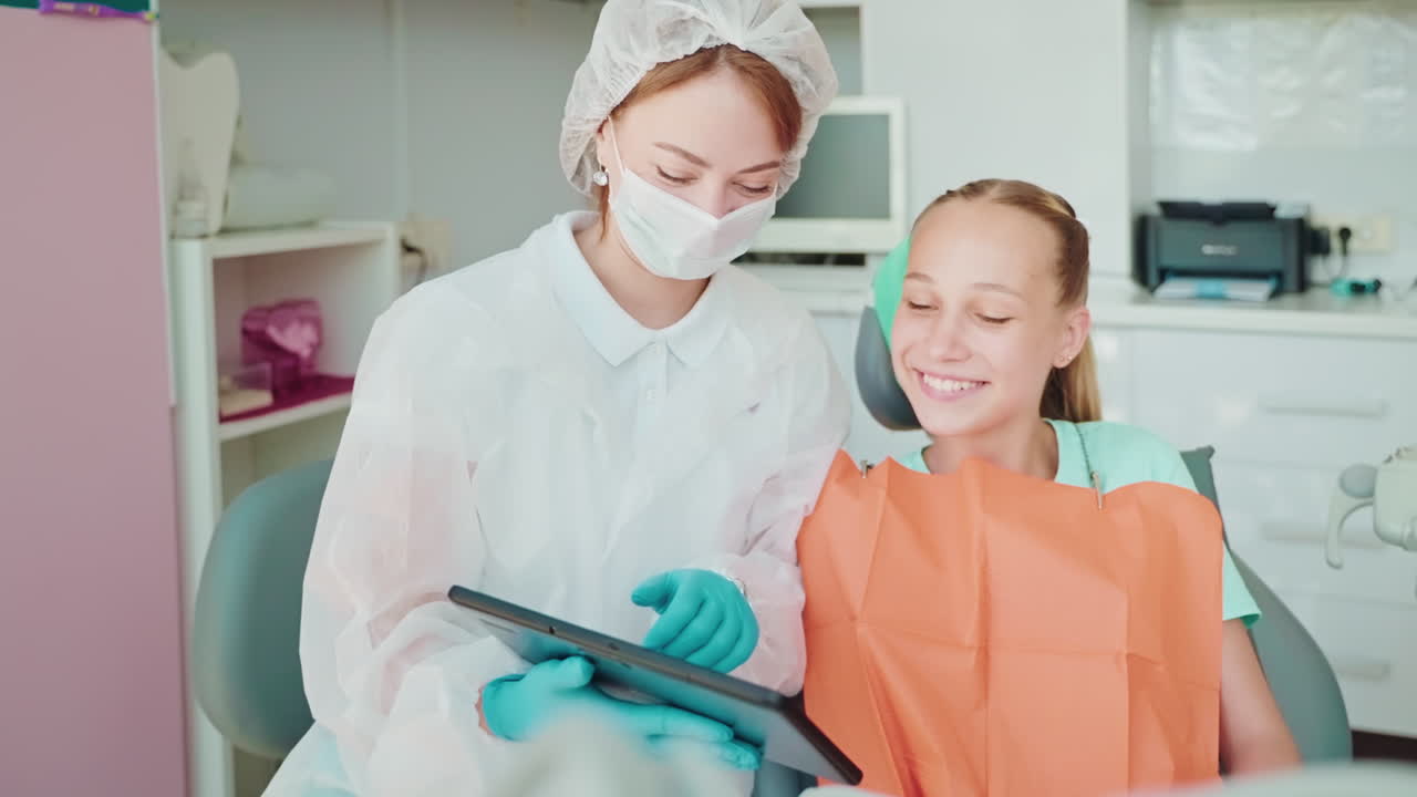 Dentist examining a patient with a tablet