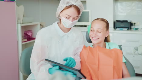 dentist examining a patient with a tablet