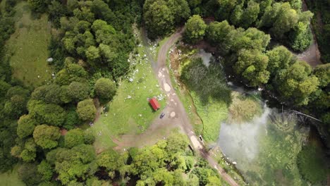 Drone-video-alpine-lake-descending-overhead-mountain-Moutsalia-Gramos-summer