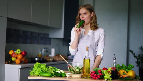 young girl thinking while eating cucumber. sad woman eating healty diet food