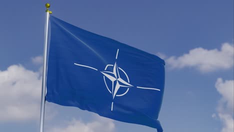 nato flag moving in the wind with a clear blue sky in the background, clouds slowly moving, flagpole, slow motion