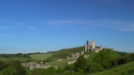 pan and zoon shot of corfe castle in early morning light, isle of purbeck, dorset, england